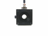 Front face of linear stage optical mount showing large circular bore opening for optical tube and four corner mounting holes