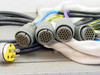 Multi-conductor cable harness included with Kaiser Marquart burn-in fixture — mil-spec circular connectors (approx. 19-pin) and yellow twist-lock AC power plug