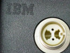 IBM 1053018 Twinax Adapter — close-up of IBM logo and round Twinax connector face showing 3-position contact arrangement