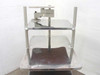 Anthro rolling computer cart rear view showing adjustable monitor arm mechanism and shelf surfaces with wear