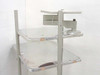 Anthro rolling computer cart close-up of upper shelves and adjustable monitor arm bracket with scuff wear visible on shelf surfaces