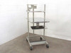 Anthro heavy duty rolling computer cart full view from front-left showing monitor arm platform, main shelf, keyboard shelf, and locking swivel casters