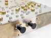 CCI RF duplexer side edge view showing two black rubber-capped ports or feed-through connectors on the lower rail of the machined aluminum cavity housing