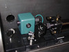 CMS PS-700 internal optics bench — Coherent Compass laser head (teal housing), beam steering optics, mirror mounts, and rail assembly visible