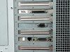 Digital AlphaServer 2100 expansion slot area – SGL-labeled card with SCSI connector, DB-9 serial card, RJ-45 network card with DB-25 connector, and two empty slot covers