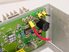 Power-One F24-12-A PCB close-up showing output regulation circuitry, resistors, and wiring harness