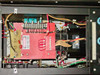 Internal chassis view – upper section showing red high-voltage transformer assembly with terminal block, warning label, and associated wiring