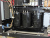 Close-up of three large black oil-filled filter capacitors inside chassis – each marked 490 650 815