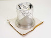 MDC Vacuum 820001 L400-1 LF Clamp in foil wrapping on cardboard, angled side view showing clear base flange