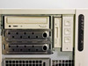 Arc PC 732765-001 front drive bay detail – CD-ROM drive installed in top bay, six empty hot-swap HDD trays, 3.5-inch floppy drive, and three empty CD-ROM bays visible
