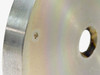 Close-up detail of stainless steel vacuum flange plate showing countersunk mounting hole and 1/2-inch center port bore