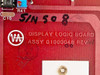 Varian Display Logic Board label closeup — reads DISPLAY LOGIC BOARD ASSY 01000048 REV M with handwritten serial number S/N 508 and Varian logo