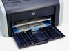 HP LaserJet 1012 — front view with paper input tray extended open, showing blue paper guides and tray frame
