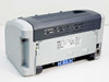 HP LaserJet 1012 Q2461A — rear view showing ventilation slots, HP rating label, toner access door open with blue latch, and power connector port