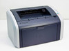 HP LaserJet 1012 Q2461A compact monochrome laser printer — front left three-quarter view showing navy and light grey casing with HP logo and output tray