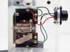 Interior view of second acrylic enclosure — spring-contact microswitch mechanism, multi-conductor wiring (red, green, white) and knurled connector visible