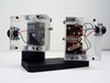 Rear view of both acrylic enclosure units open — left unit shows Micro Switch module with 9228 label, right unit shows spring-contact mechanism and wiring