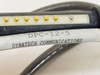 Dynatech DPC-12-5 label on cable connector showing model number and Dynatech Communications brand name, with gold pogo pin contacts visible