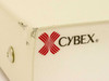 Cybex logo close-up on Commander Personal II KVM switch – shows paint chips and wear on top corner of beige metal enclosure