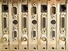 Cubix LCS Resource SubSystem rear card bracket close-up showing RJ45, DB9 serial, DB15, mini-DIN, and BNC connectors across multiple expansion cards
