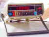 Keithley 177 Microvolt DMM front panel powered on, LED display showing -000.0, with tilt bail and test lead inputs visible