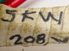 Titan Industrial heating element body with hand-written markings reading 5kW and 208V on wrapped refractory tape