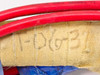 Titan Industrial heating element end showing hand-written part number T-06-37 on refractory wrapping with red supply lead visible