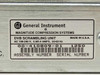 General Instrument Magnitude 00-410809-01 DVB Scrambling Unit – rating plate label showing Assembly Number 00-410809-01, AC 100-240V 0.8/0.4A 50-60Hz, Made in U.S.A., Serial Number 1250