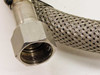 Close-up of female threaded hex fitting on Consolidated Precision B-8000-016-096 braided vacuum hose showing thread detail and stainless braid construction
