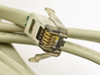 Close-up of RJ11 modular connector end of IBM 73G8856 POS cable showing gold contacts and clear plastic housing