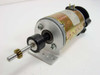 Buhler DC motor side view showing full assembly with shaft, pinion gear, brass can body, and mounting bracket