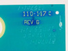 Close-up of 110-147C PCB silkscreen label showing part number 110-147C and REV G markings in yellow on teal board surface