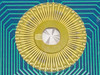 Macro close-up of the radial gold contact array on the 110-147C Rev G DAS Device PCB showing labeled contact pads B1 through B33 arranged in a circular pattern