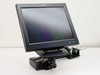 Kensington K60106 desk mount arm with Planar PE1700-BK 17-inch LCD monitor attached — three-quarter front-left view showing arm and clamp assembly