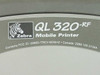 Zebra QL320-RF mobile printer branding label with FCC ID and Canada certification markings