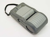 Zebra QL320-RF mobile label printer front view with carry strap and paper exit slot