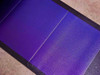 Uni-Solar PVL-144 amorphous solar cell surface closeup showing deep purple thin-film cells and black border framing