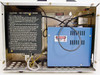 Phase Metrics Lamphouse interior — top-open view showing lamp change instructions placard, blue power supply module, wiring, and ventilated chassis