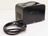 HIOS MC-60L DC Transformer rear and side view showing ventilation slots, carry handle, and attached AC power cord coiled beside unit