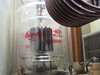 Close-up of Eimac SK-406 triode vacuum tube with Varian branding visible on glass envelope inside the RF deck