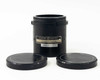 General Electric GS-028 projector lens in black cylindrical housing standing upright next to both lens caps, label showing 1.5 to 1 throw ratio and model GS-028