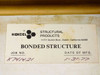 Hexcel Structural Products bonded structure label showing Job No. K741421 and Date of Manufacture 1-31-77, affixed to gold-anodized enclosure lid