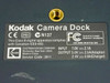 Kodak Camera Dock bottom label showing input 7.0V 2.1A, output specs, FCC/CE markings, and Made in China