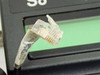 Closeup of RJ connector on Hypercom S8 PIN pad coiled cable showing connector pins and cable wrap