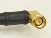 Close-up of gold SMA right angle male connector end showing center pin and right-angle body