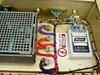 Hughes FM Data Detector interior close-up – Acopian AC to DC Power Module, high-voltage warning label, multiple toroidal transformers, and wiring harness