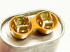 Dayton 4X429A oil capacitor — top-down view of dual terminal wells with quick-connect brass terminals