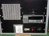 ISR Spraycool front panel detail — heat exchanger fins on left, Fluke Hydra data acquisition unit center, fan speed control knob upper right, channel input label card lower left, power switch and connectors lower right