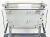 Underside of laminator platen assembly — aluminum plate with mounting pins and support structure visible with unit arm fully raised