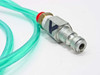 Close-up of quick-connect pneumatic air fitting on green tubing – metal quick-disconnect coupler with red and blue color-coded collar bands